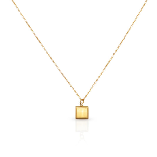 Gold necklace with a square pendant on a white background