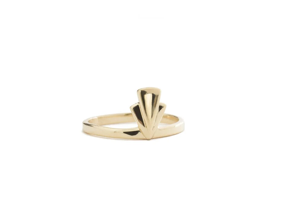 A gold Art Deco style ring featuring a fan-shaped op detail on a slim band, shown against a plain white background.