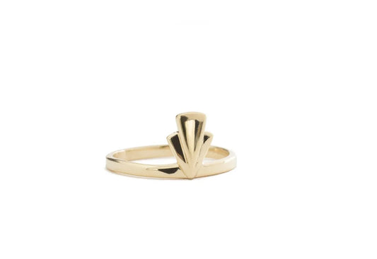 A gold Art Deco style ring featuring a fan-shaped op detail on a slim band, shown against a plain white background.