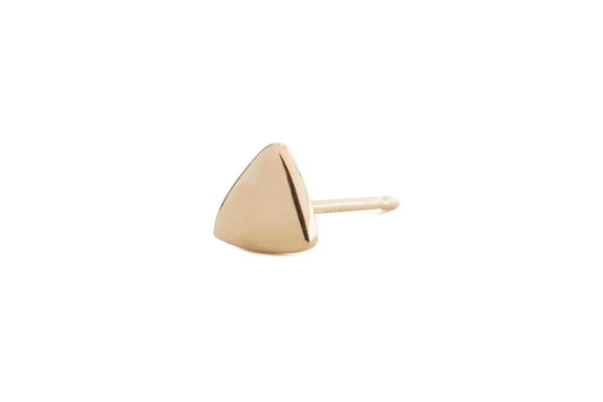 A single gold triangle stud earring with a triangular faceted top and a straight post, shown on a plain white background.