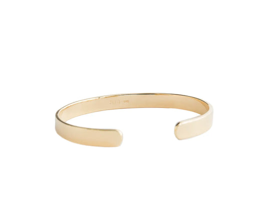 A minimalist open cuff bracelet in polished yellow gold, shown against a solid white background.