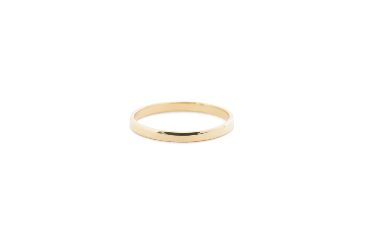 Plain polished gold ring band on white background 