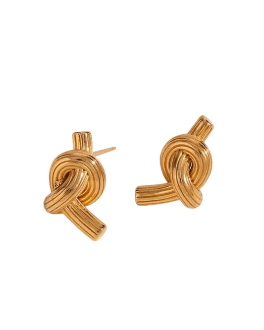 A pair of gold-toned knot stud earrings with a textured, ribbed finish, shown on a plain white background.
