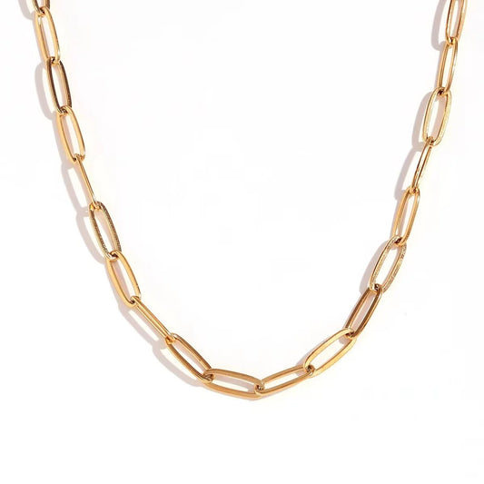 Gold paperclip chain necklace on a white background
