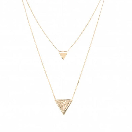 A double-layered gold necklace set featuring a delicate chain with a small triangle pendant and a longer chain with a larger, faceted triangle pendant, displayed on a clean white background.