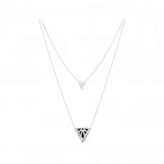 A double-layered silver Rise Drape necklace featuring a delicate top chain with a small flat triangle pendant and a longer bottom chain with a larger triangle pendant containing a black geometric pattern, set against a plain white background.
