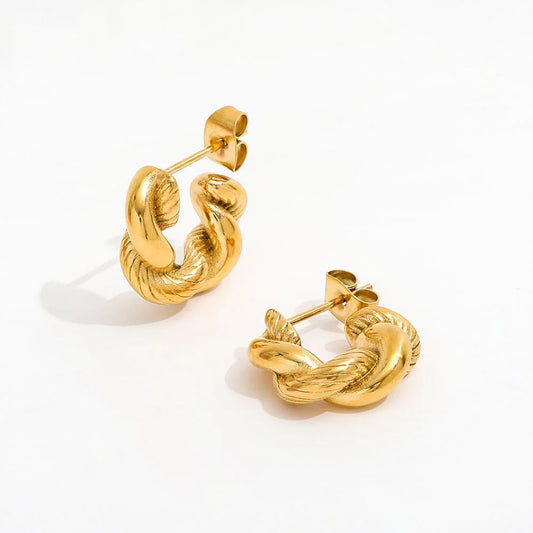 A pair of gold hoop earrings with a twisted rope design, displayed on a clean white background.