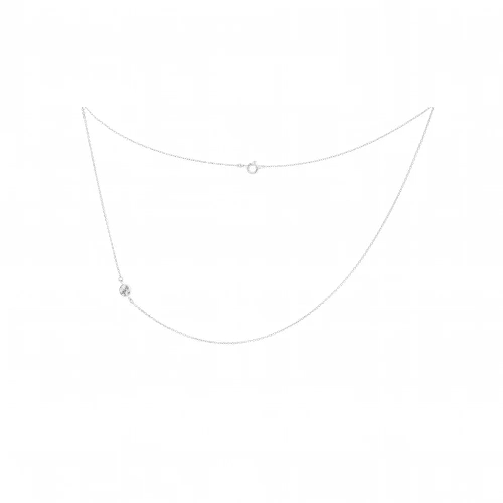 A delicate silver drop drape necklace with a small, melted effect disk on the left side, displayed on a solid white background.