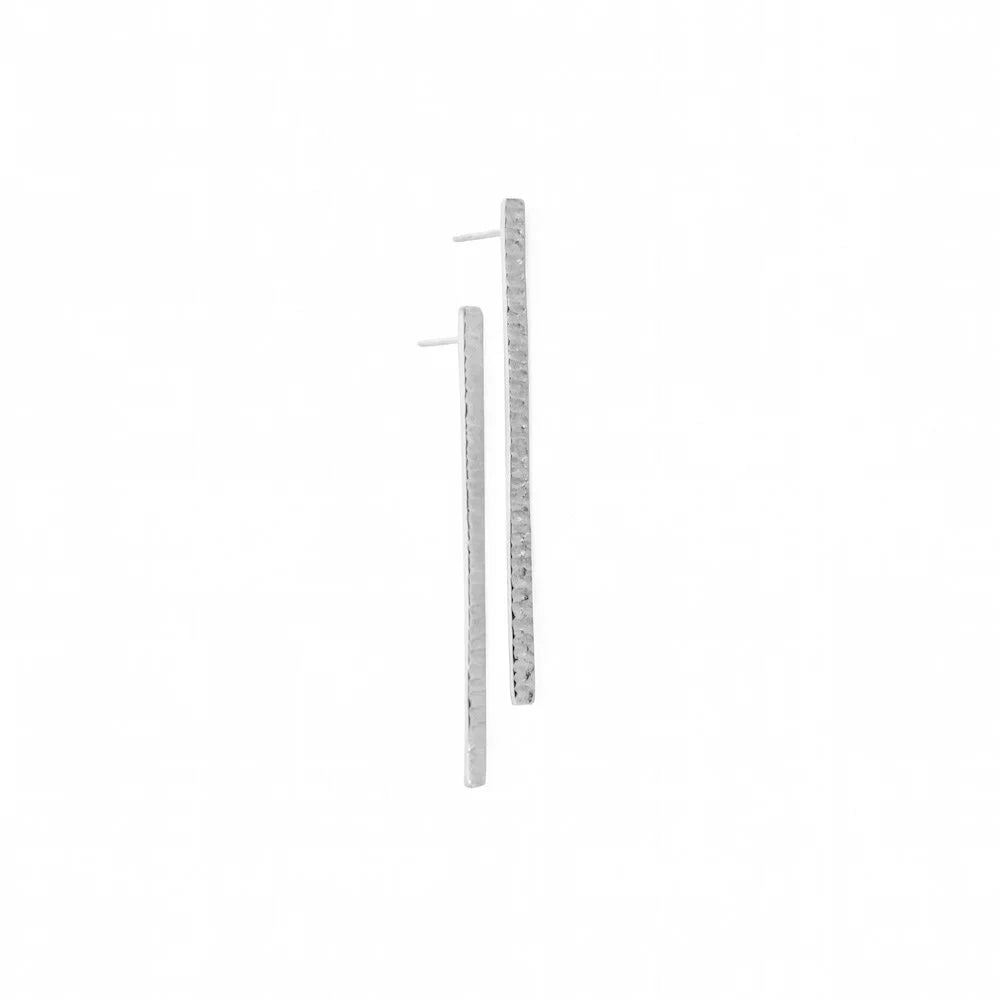 A pair of long, thin gold bar earrings with a textured finish and post backs, shown on a plain white background.