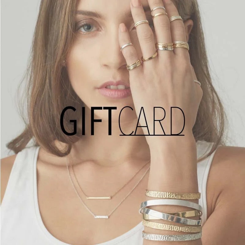 A close-up of a woman wearing multiple gold and silver rings on her fingers and stacked bracelets on her wrist, with a necklace around her neck. Large text reading 'GIFT CARD' is overlaid across the center.